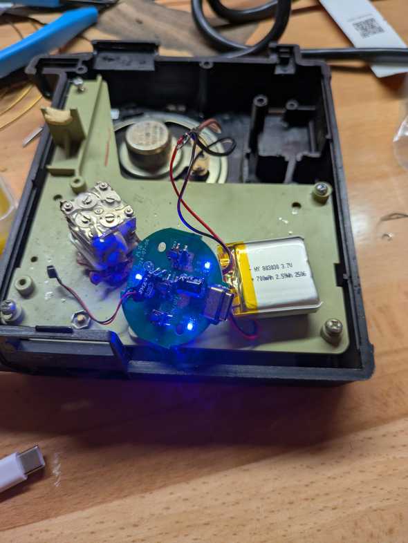 an old transistor radio with a bluetooth speaker soldered in