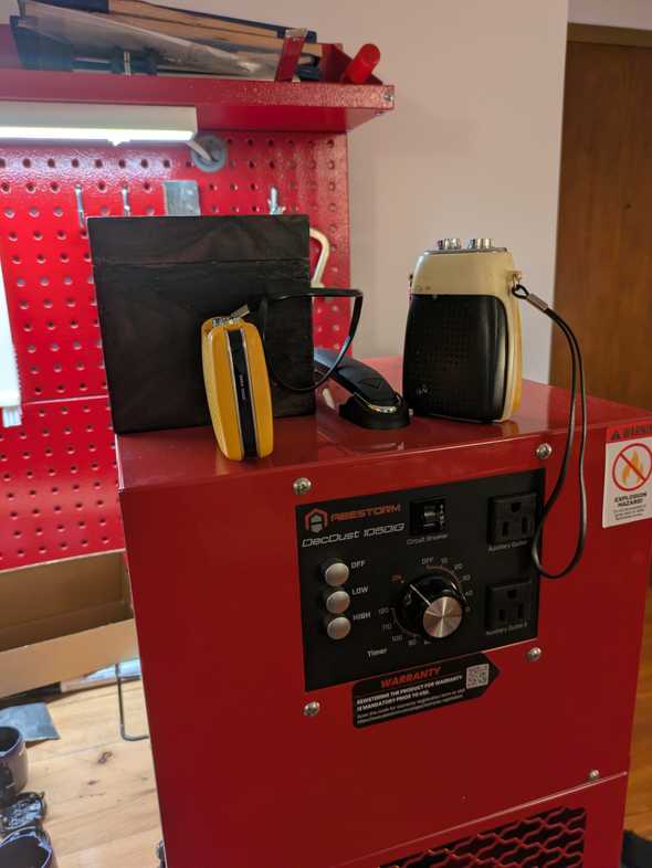 three vintage radios atop a red cube