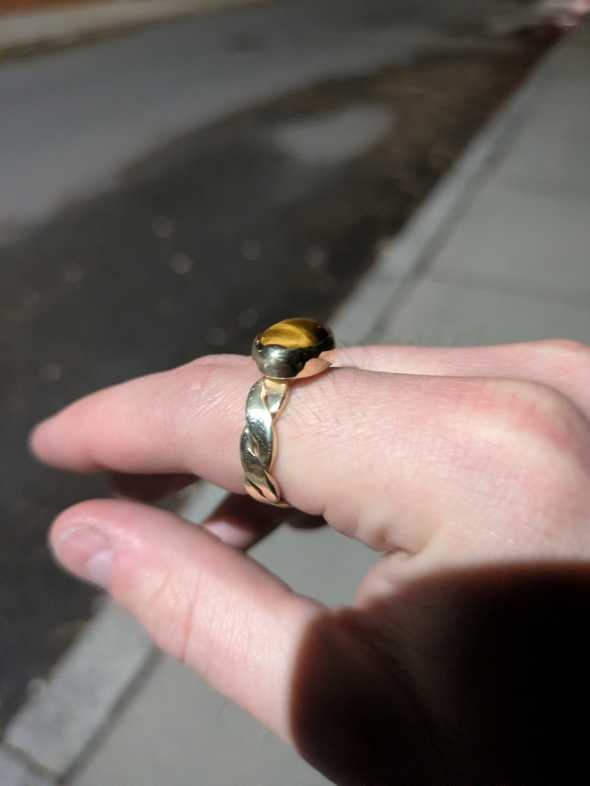 a ring with a twisted band and bezel setting