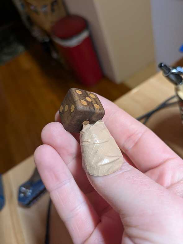 the finished dice held aloft